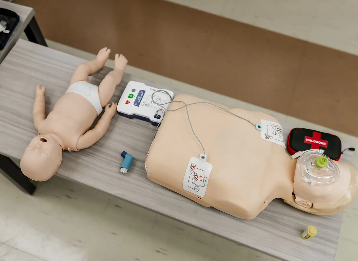 CPR, AED, and first aid equipment prepared for a course.