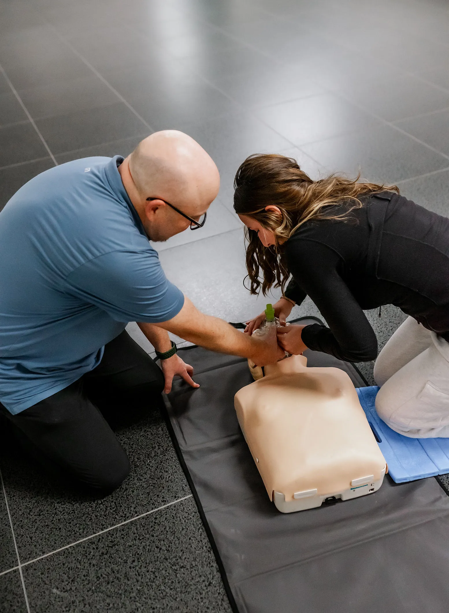 Instructor teaching a student during CPR training.